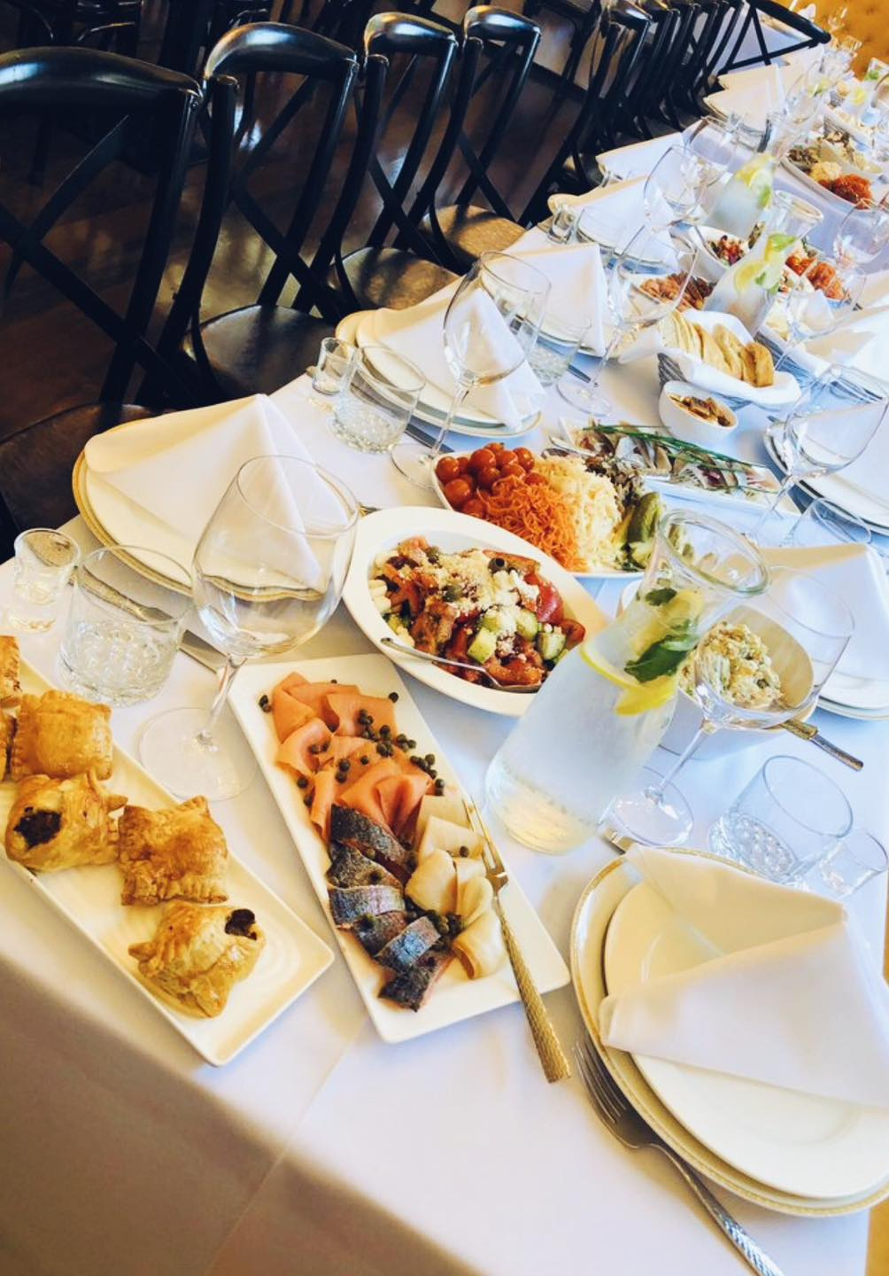 Catering Platters Catering platters of savory pastries, smoked salmon and salads on a white-linen table