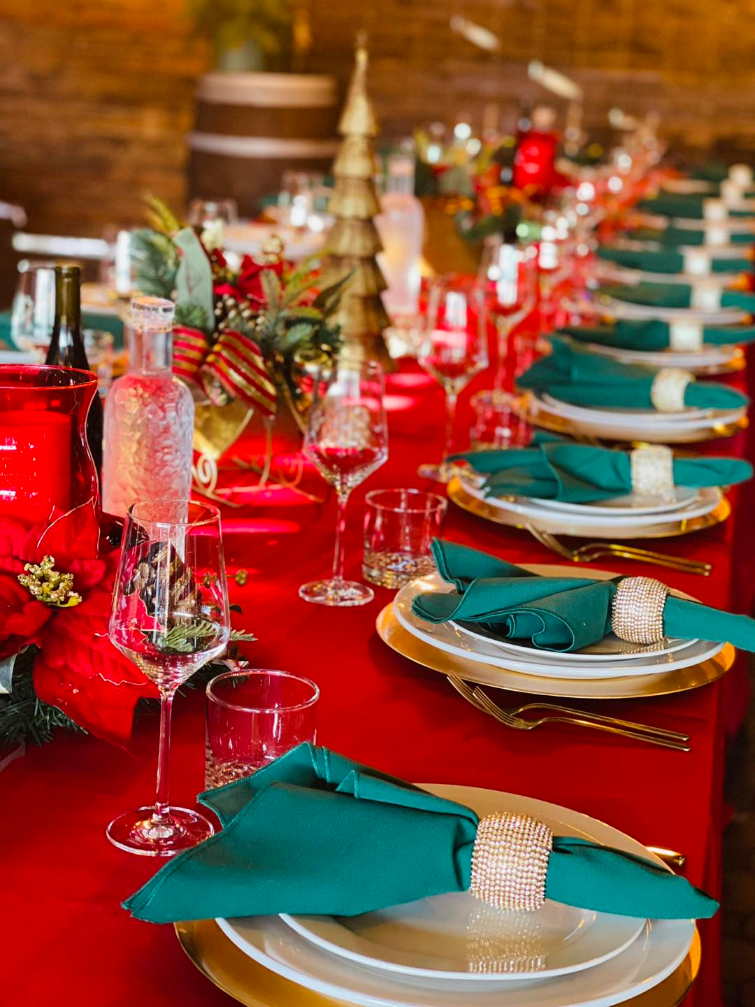 Holiday Party Table Setting Holiday party table with red linens, green napkins and festive decor by JC Bruno