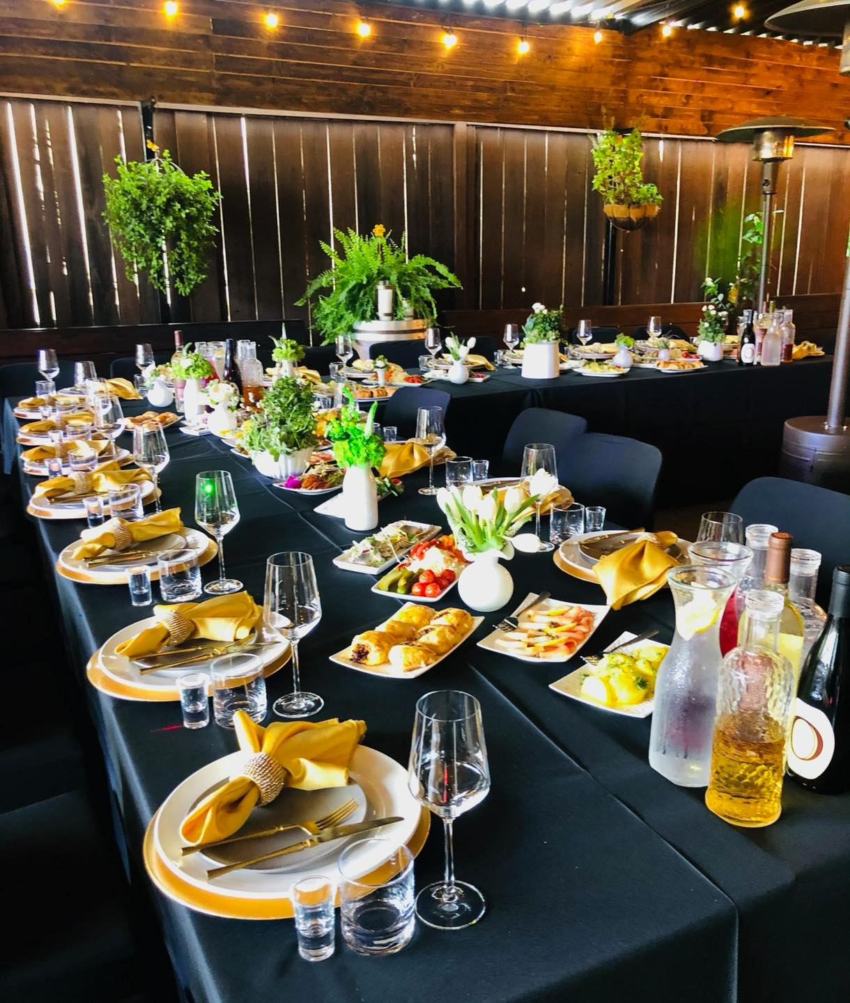 Private Event Banquet Table Banquet table set with gold chargers and appetizers for a private event by JC Bruno Restaurant