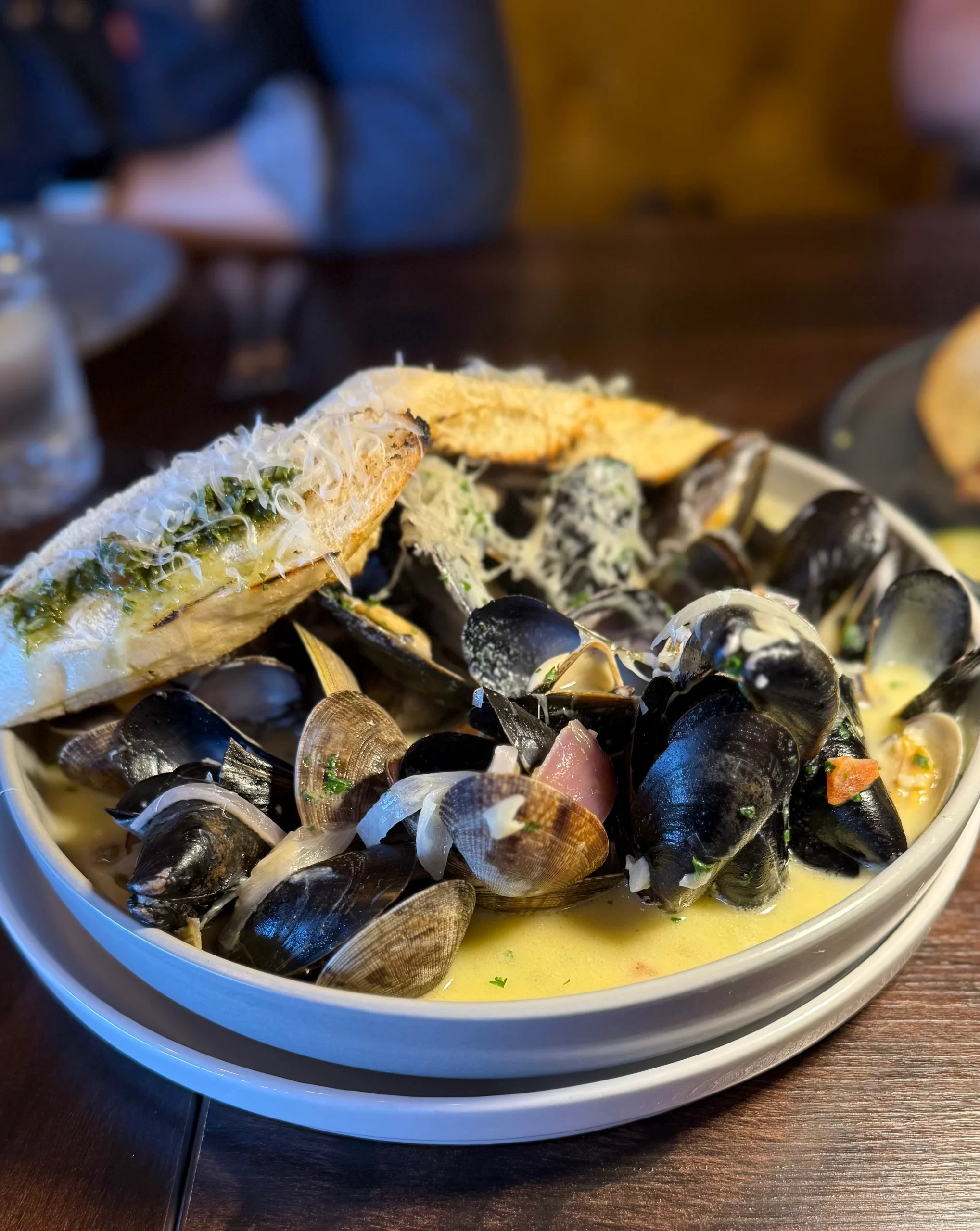 Steamed Mussels and Clams Steamed mussels and clams in white wine sauce with garlic toast